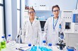 © Krakenimages.com - Young mother and daughter at scientist laboratory with serious expression on face. simple and natural looking at the camera.