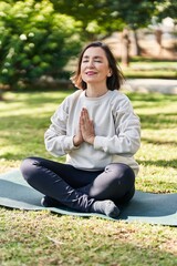 Poster - Middle age woman smiling confident training yoga at park