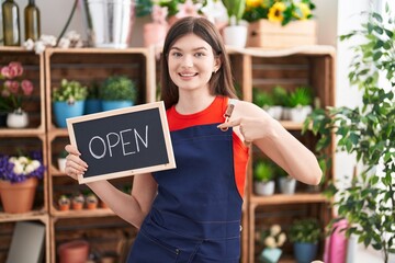 Canvas Print - Young caucasian woman working at florist holding open sign pointing finger to one self smiling happy and proud