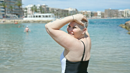 Poster - Middle age grey-haired woman tourist wearing swimsuit relaxed with hands on head at the beach