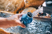 Pouring Water From A Spring Source At Camping Or Hiking. Clean Looking Water Can Be Contaminated And Dangerous To Health