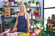 © Krakenimages.com - Young blonde woman florist make bouquet of flowers at florist store