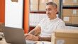 © Krakenimages.com - Young hispanic man ecommerce business worker using laptop at office