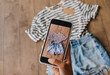 © lavju83 - Woman taking picture of used clothes. Selling used clothes concept.