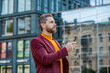 © be free - stylish man messaging on smartphone outdoor. man messaging on smartphone