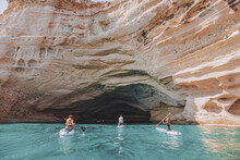 Group Of Sup Boarders Enters Huge Limestone Cave On A Sea Coast