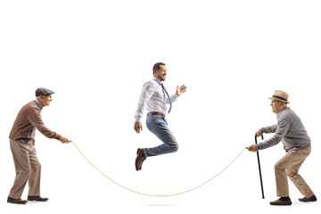 Sticker - Full length shot of two senior men playing skipping rope with a younger man