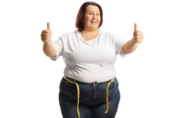 Sticker - Cheerful corpulent woman in jeans with a measuring tape around waist gesturing thumbs up