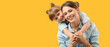 © Pixel-Shot - Portrait of happy mother and daughter on yellow background. Banner for design