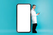 © Prostock-studio - Grey-haired doctor posing by smartphone with mockup, using digital tablet