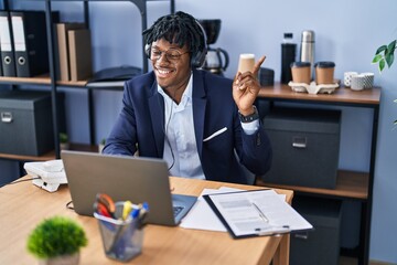 Sticker - Young african man with dreadlocks working at the office wearing headset smiling happy pointing with hand and finger to the side