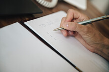 Closeup view of female hand writing a To do list