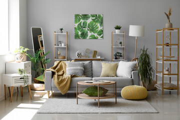 Sticker - Interior of light living room with grey sofa, houseplants and mirror