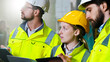 © ihorvsn - Close up of Caucasian team of builders at construction site talking and discussing work with tablet.