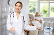 © JackF - Positive confident female doctor standing while elderly patient laying on treatment chair and looking in mirror.