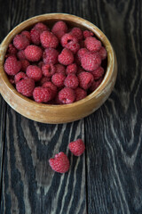 Wall Mural - Fresh ripe raspberry on a wooden plate