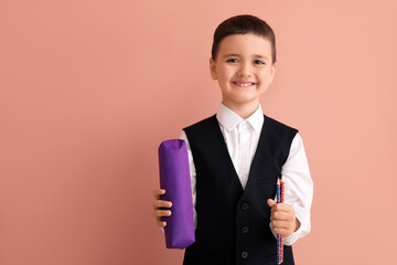 Poster - Cute little schoolboy with pencil case on color background