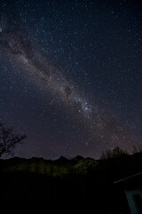 Wall Mural - The Milky Way Galaxy moving over the mountain ridge. Night lapse from night to day. Starry night.