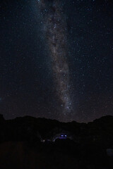 Wall Mural - The Milky Way Galaxy moving over the mountain ridge. Night lapse from night to day. Starry night.
