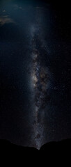 Wall Mural - The Milky Way Galaxy moving over the mountain ridge. Night lapse from night to day. Starry night.