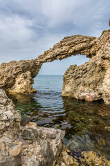 Wall Mural - Natural stone arch over water in mediterranean sea. Costa Brava, Spain