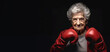 Elderly senior woman wearing red boxing gloves, confident smiling expression ready for fight. Wide banner copy space on side. Generative AI