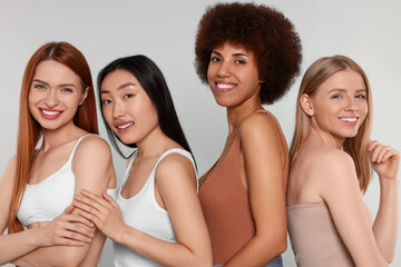 portrait of beautiful young women on light grey background