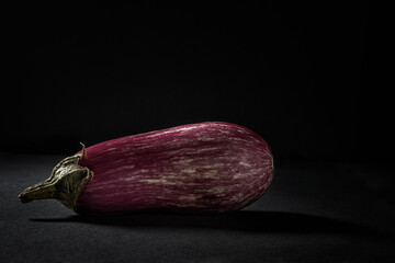 Canvas Print - Fresh striped zebra eggplant on black background