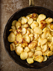 Wall Mural - close up of rustic golden german pan fried potato bratkartofflen