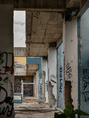 Wall Mural - Internal structure of the abandoned buildings with bricks texture were left to deteriorate over years. The graffiti patterns on the wall were left. Selective focus.