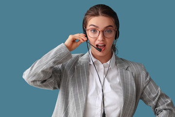 Canvas Print - Surprised female technical support agent on blue background