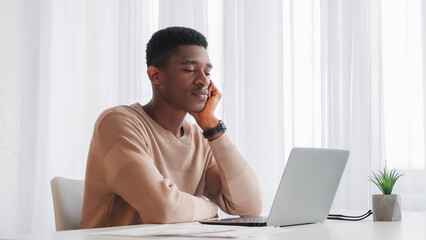 Boring work. Learning fatigue. Online education. Exhausted tired drowsy sleepy stressed young man at laptop webinar class video call at home desk.