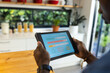 © Wavebreak Media - African american man using tablet with smart home interface in kitchen at home