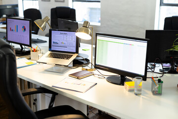Close up of computer, laptop, notebook and documents on desk in office