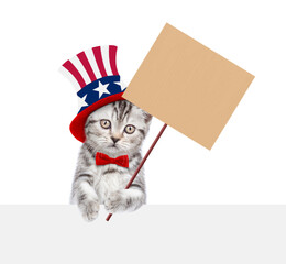 Poster - Cute kitten wearing like Uncle Sam looks above empty white banner and shows empty placard. isolated on white background