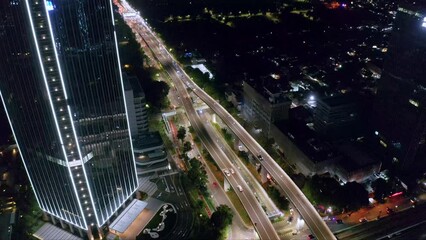 Wall Mural - Scenic Night View Of Overpass Roads At The Modern Cityscape Of Kuningan City In South Jakarta, Indonesia. Aerial Shot