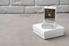 Golden Jewellery In Box On Gray Background
