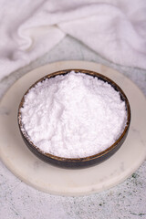 Wall Mural - Wheat starch on stone background. Wheat starch in bowl. close up