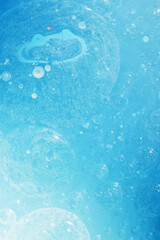 Wall Mural - Oil bubbles close up. circles of water macro. abstract light blue background