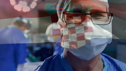 Poster - Animation of waving croatia flag over portrait of caucasian male surgeon at hospital