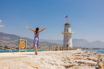 Wall Mural - Tourist woman near lighthouse in Alanya, Antalya district, Turkey