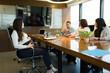 © AntonioDiaz - Pregnant woman giving job interview to recruiters in modern office
