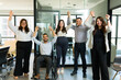 Group of diverse office employees celebrating success