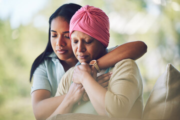 Love, sweet and woman with her mom with cancer hugging, bonding and spending time together. Recovery, chemotherapy and sick mature female person embracing her adult daughter in an outdoor garden.