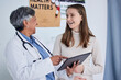© Nadia L/peopleimages.com - Pregnant woman, doctor and tablet for happy results, gynecology service and healthcare news, exam or progress. Medical gynecologist, nurse or people for pregnancy, digital technology or growth check