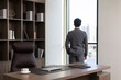 © Blue Jean Images - Successful Chinese businessman looking through window