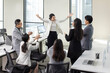 © Blue Jean Images - Cheerful Chinese business people applauding in office