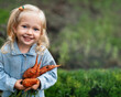 © Natalia Shmatova - Close up Adorable toddler smiling blond girl in blue outfits holding carrots in domestic garden. Healthy organic vegetables for kids. Picked Fresh Vegetables Just From The Garden