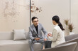 © Blue Jean Images - Confident Chinese business people talking in meeting room