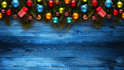 Poster - Merry Christmas Frame with real wood green pine, colorful baubles, gift boxe and other seasonal stuff over an old wooden aged background